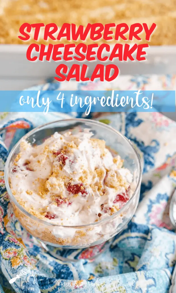 Top down view of a glass dish filled with a Strawberry Cheesecake Salad that's been garnished with graham cracker crumbs. The title appears across the top for Pinterest.