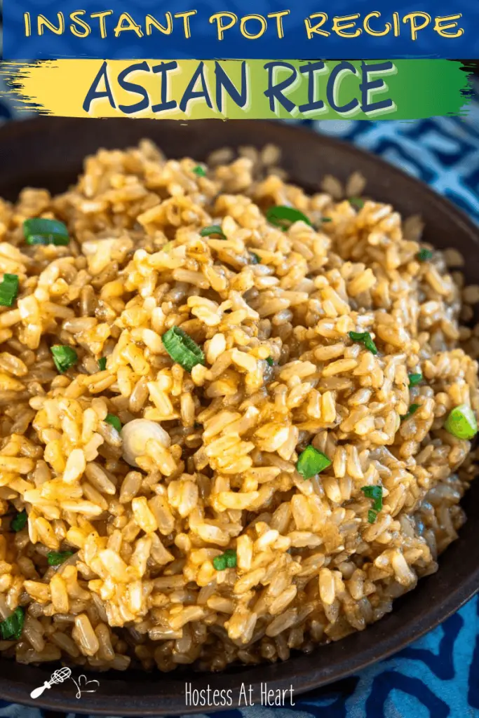 Top down view of a bowl filled with saucy brown rice garnished with sliced green onion.