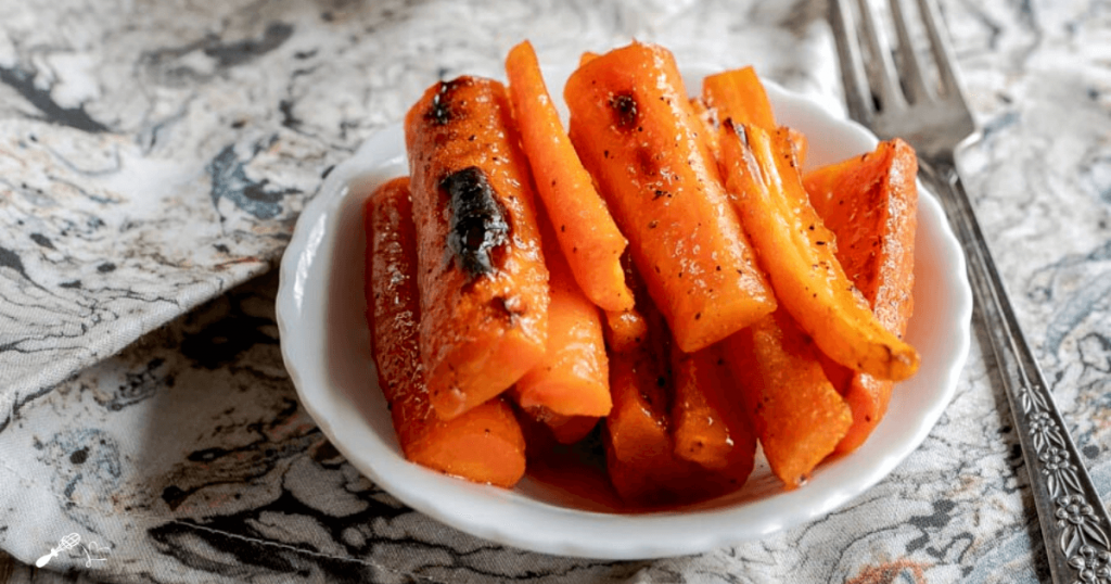 3/4 angle photo of a dish of sliced carrots.
