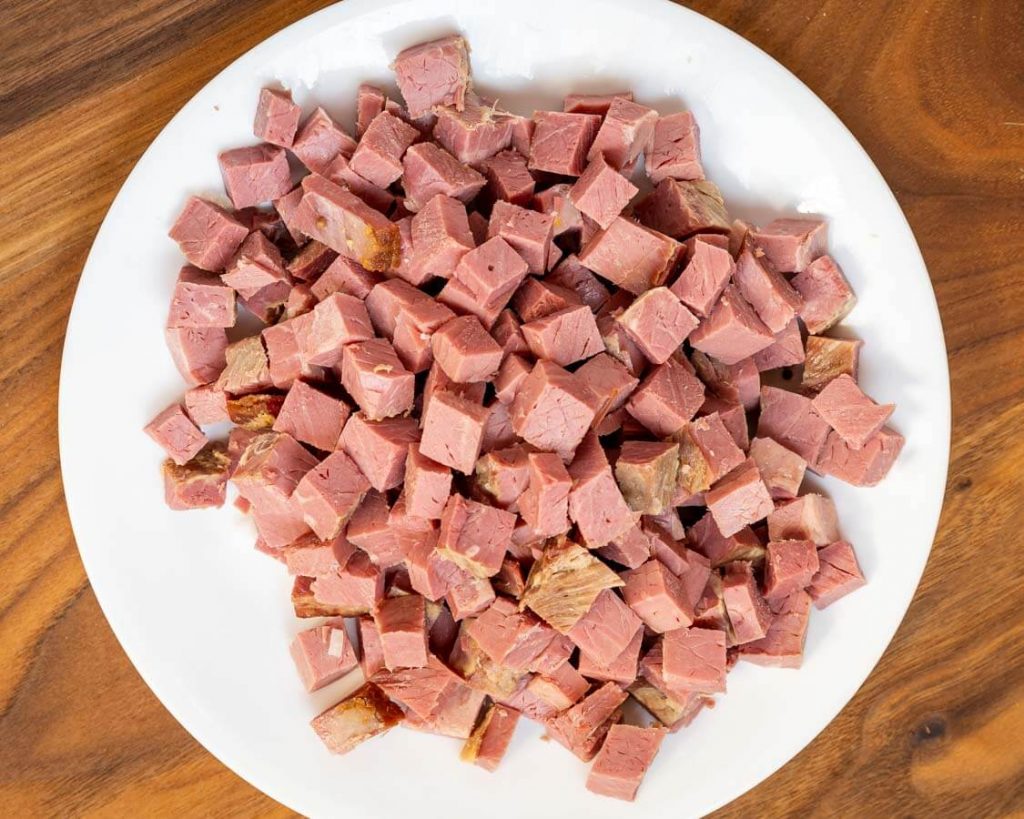 Top down view of diced corned beef on a plate.