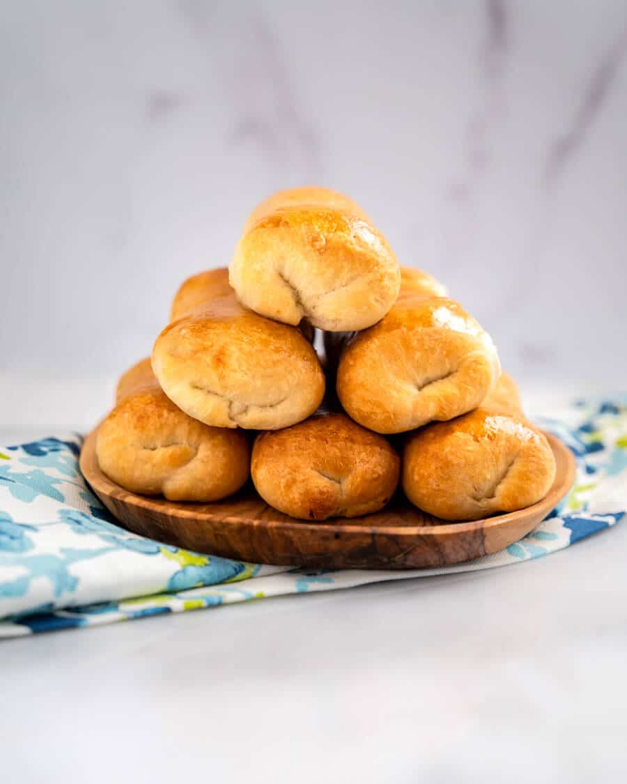 Table view of baked meat-filled buns in a stack of six.