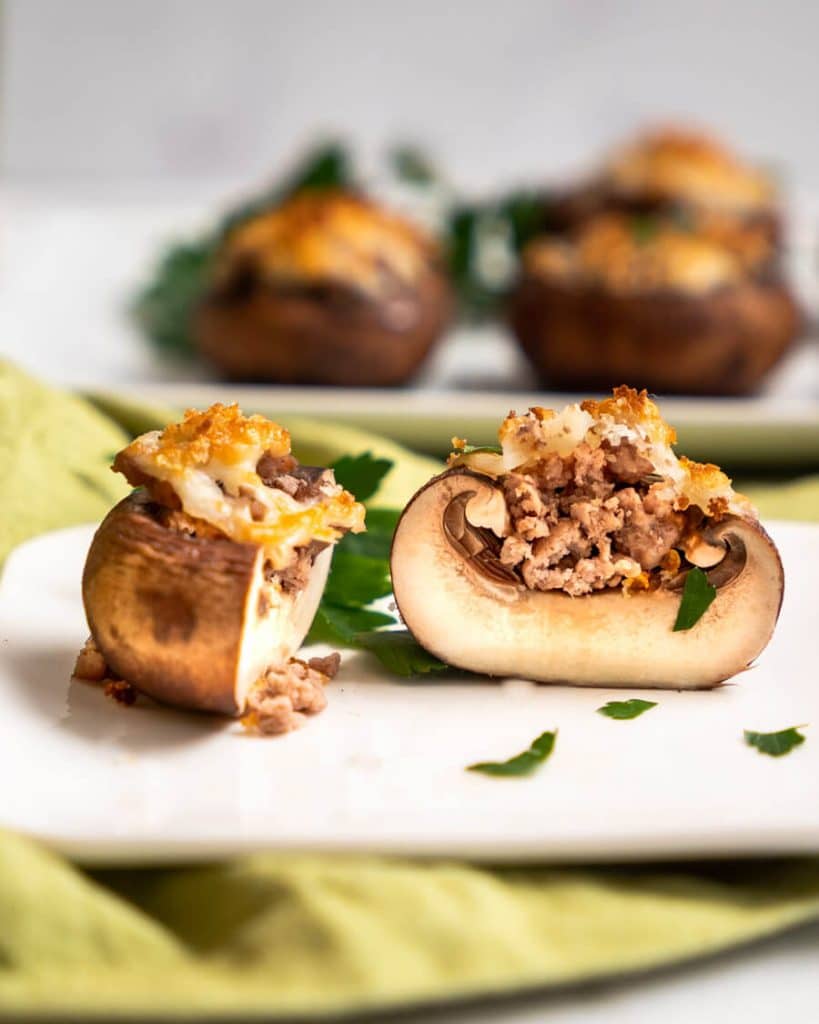 Tableview photo of a stuffed mushroom cut in half showing the filling.