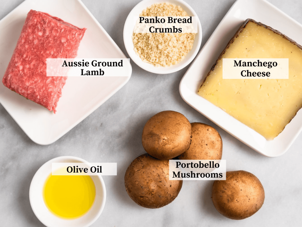 Ingredients used to make stuffed mushrooms including ground lamb, mushrooms, manchego cheese, and olive oil.