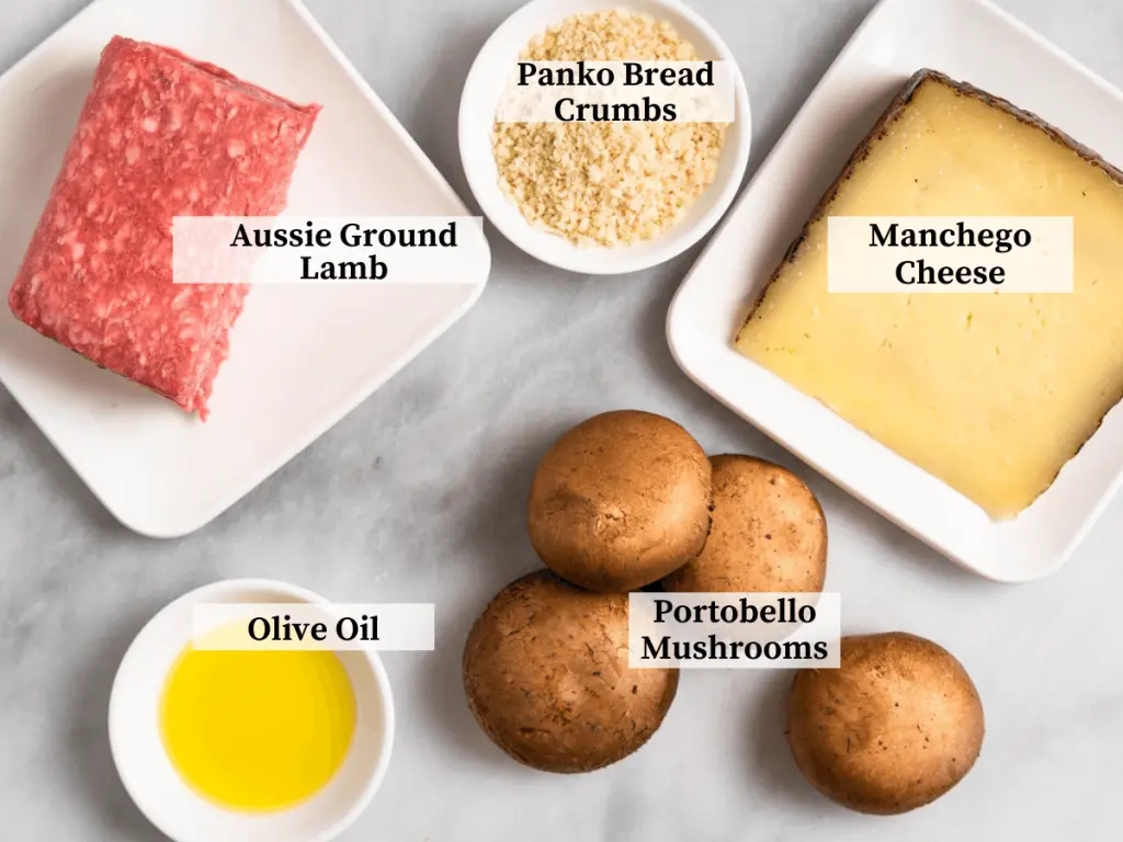 Ingredients used to make stuffed mushrooms including ground lamb, mushrooms, manchego cheese, and olive oil.