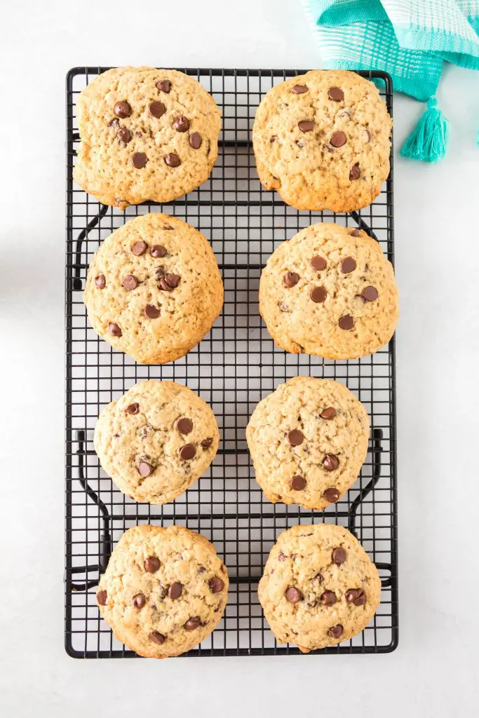 Top down view of chocolate chip cookies sitting on a cooling rack.