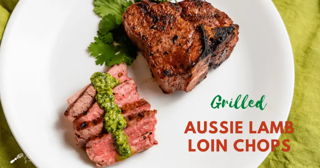 Sliced lamb with a drizzle of pesto in front of an uncut grilled lamb chop
