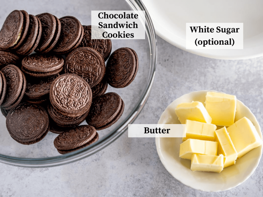 A bowl of oreo cookies next to a dish of butter.