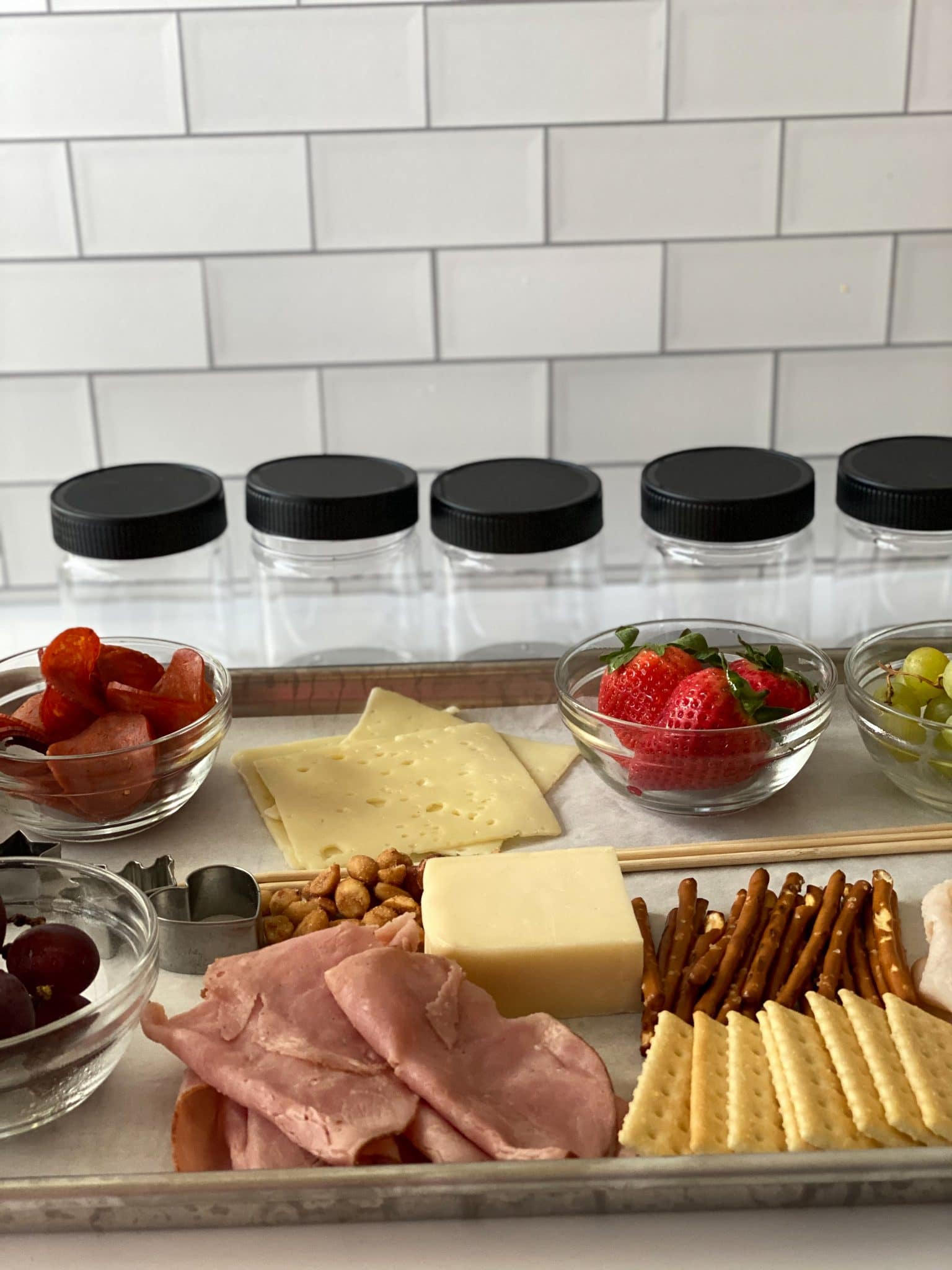 Make your own jarcuterie tray with fruit, meat, cheese, and nuts.