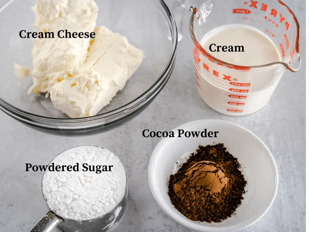 Ingredients used in chocolate cheesecake pie including powdered sugar, Cocoa Powder, Cream and cream cheese