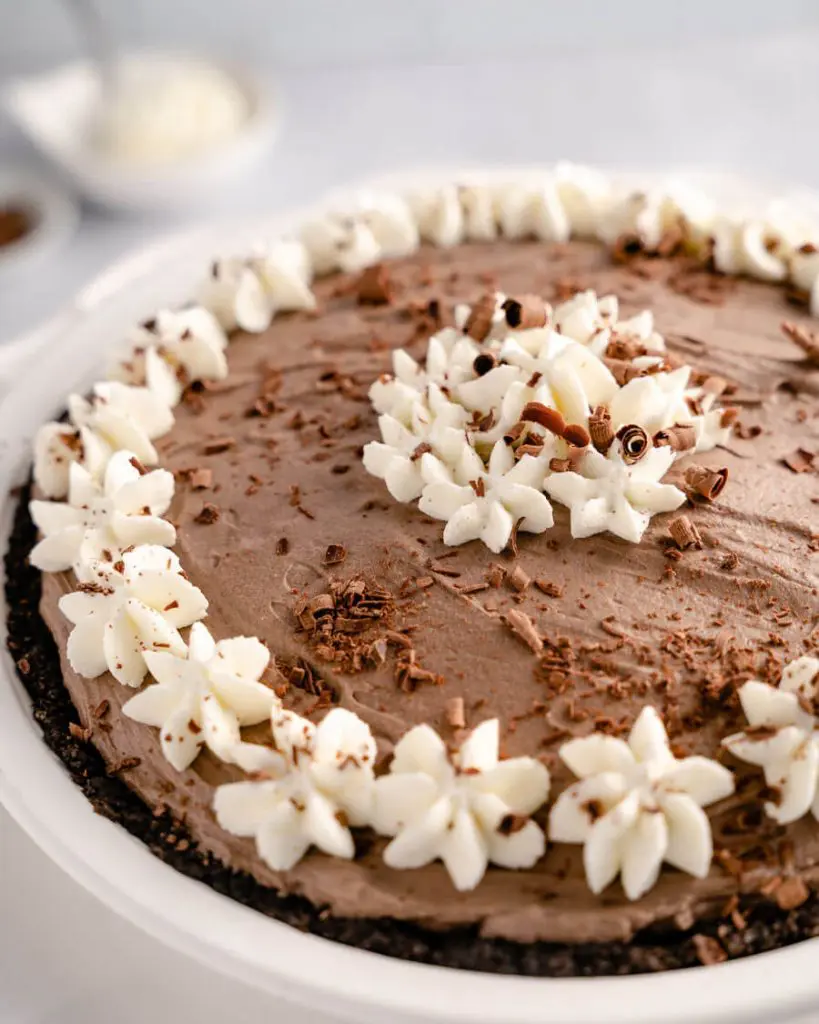 Close-up 3/4 Angle of a chocolate pie decorated with whipped cream stars and chocolate curls