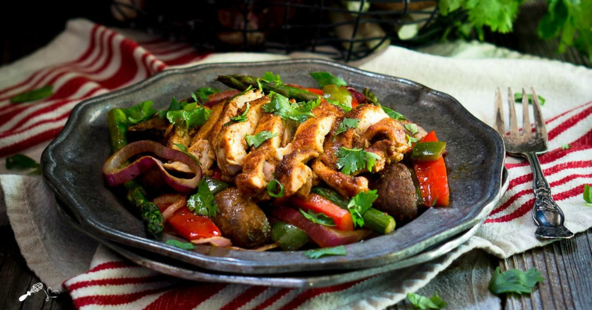 3/4 Angle of baked vegetables topped with chicken and parsley