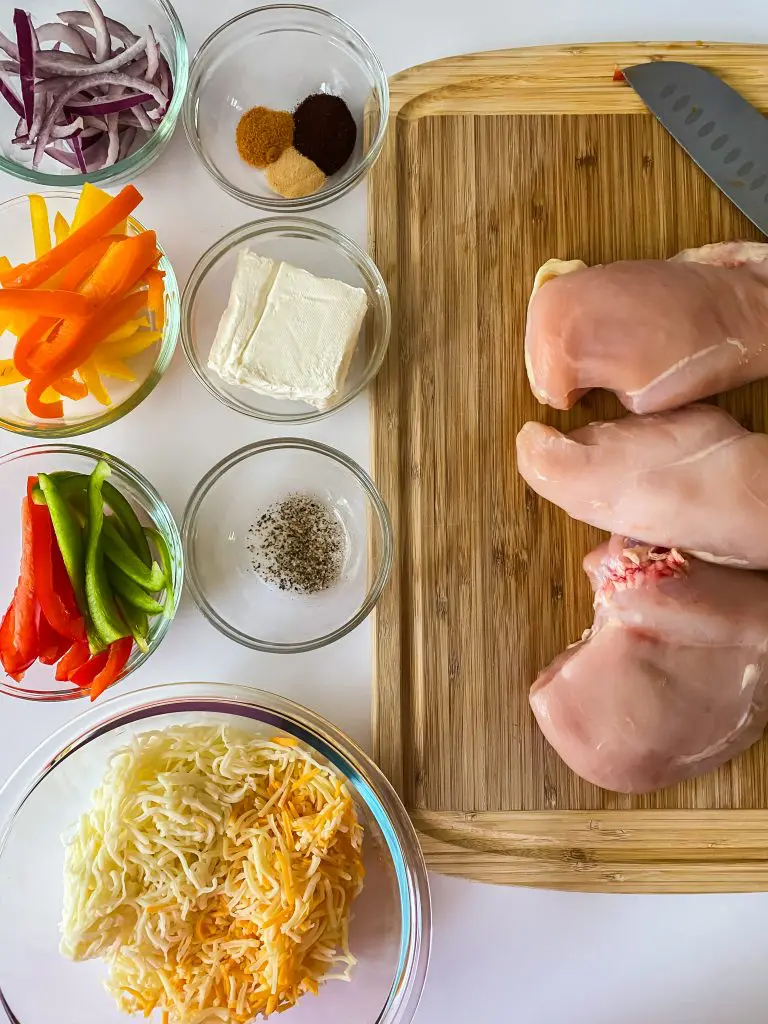 Ingredients for the fajita stuffed chicken recipe: Chicken, cream cheese, Mexican cheese blend, peppers, onions, seasoning blend.