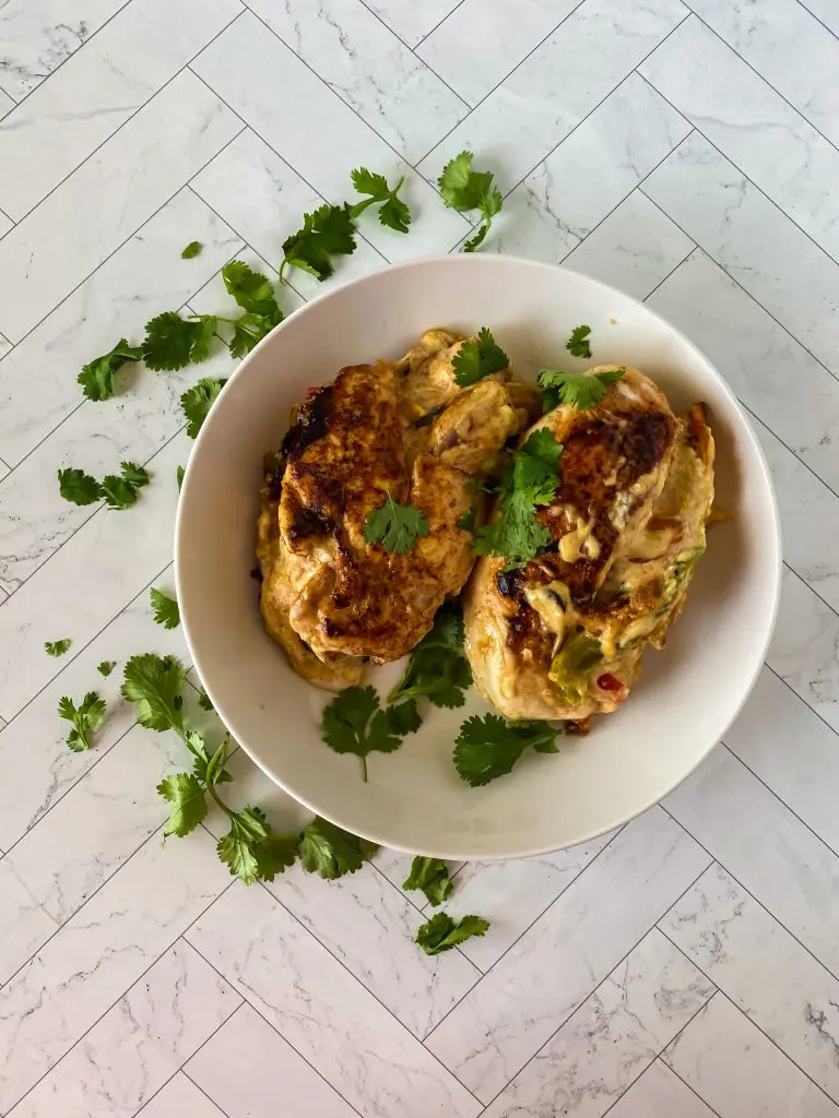 Beautiful platter of fajita stuffed chicken breasts with soft lighting.