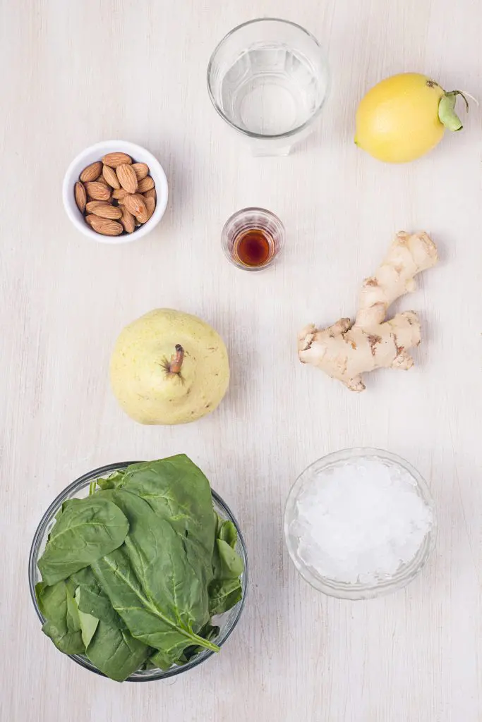 Ingredients for pear smoothie: almonds, ginger, pear, spinach, lemon juice, water, crushed ice, vanilla.
