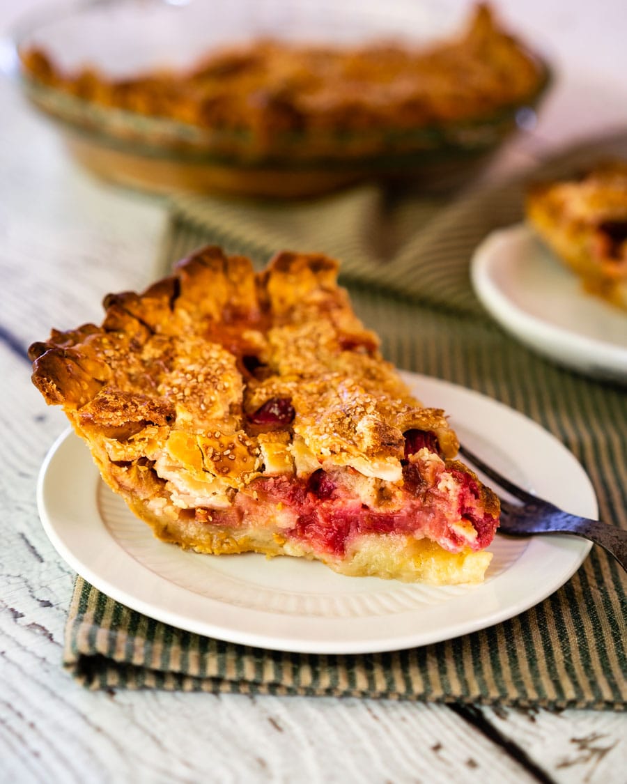Side view of a slice of rhubarb pie sitting on a plate