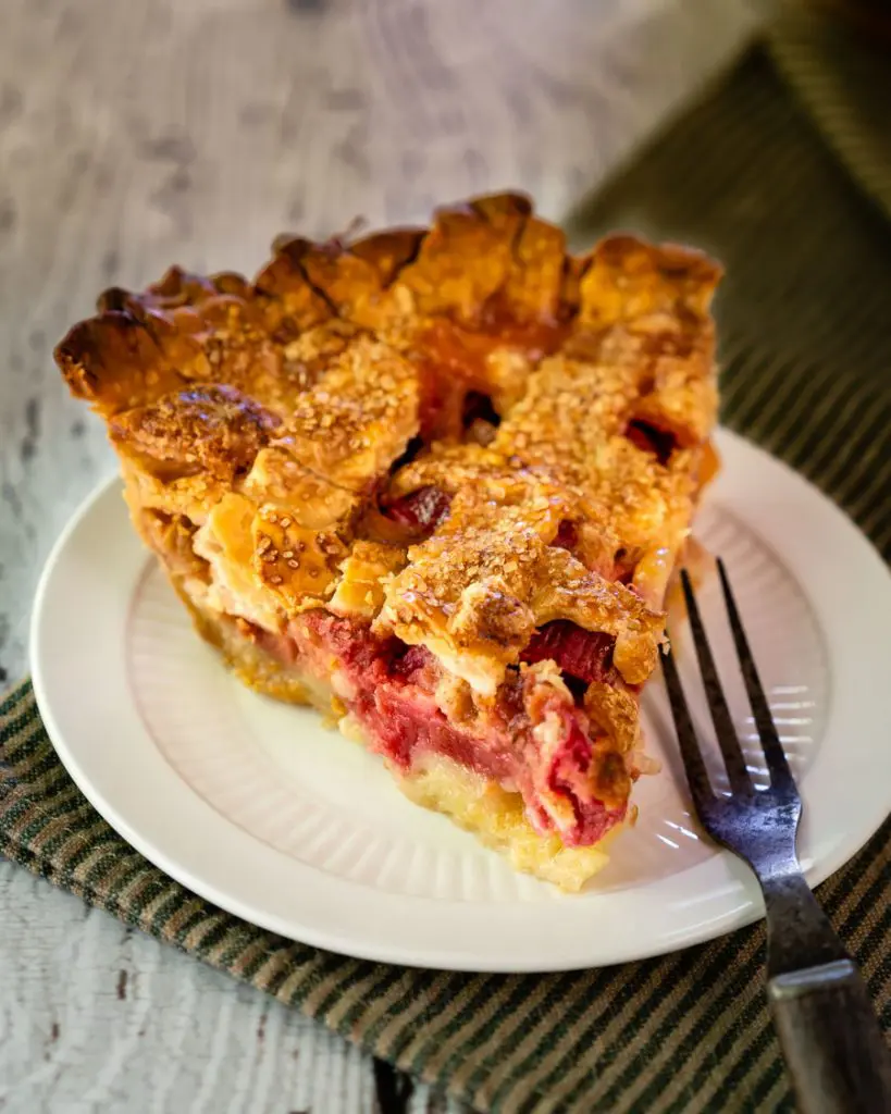 Front view of a slice of lattice pie sitting on a plate