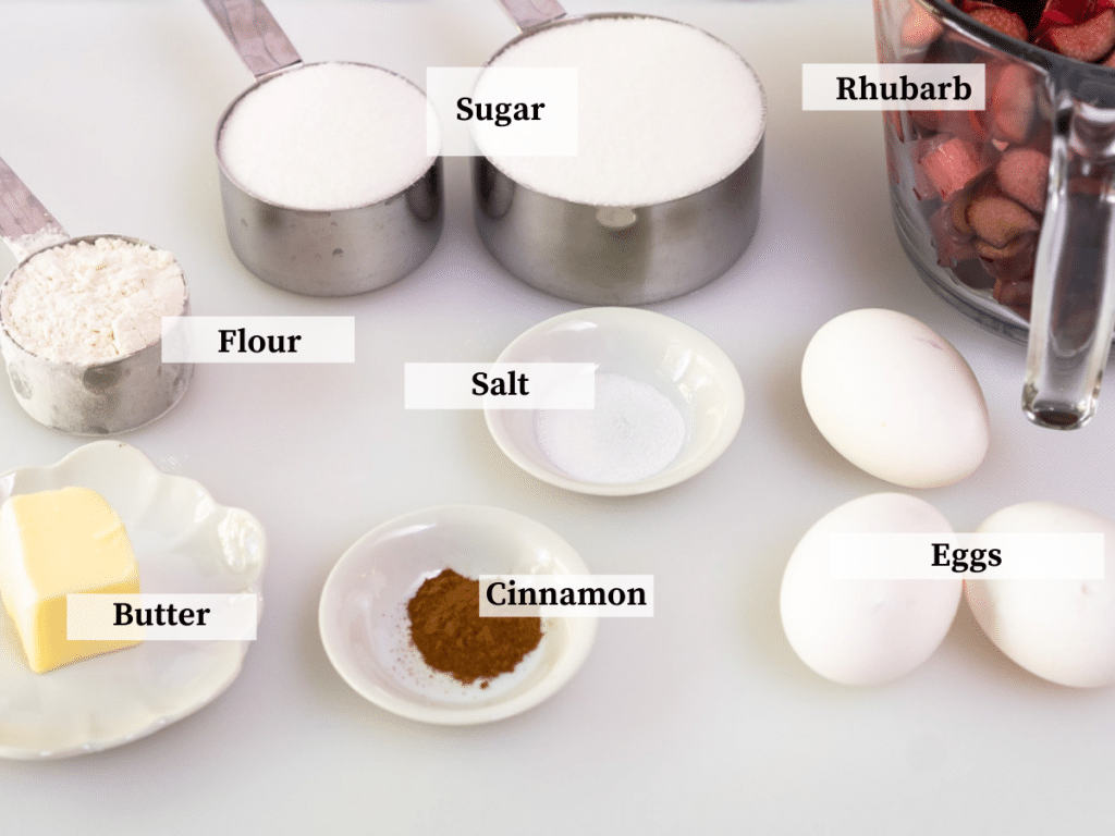 Ingredients used to make a rhubarb custard filling including eggs, flour, sugar, butter, cinnamon, salt, and rhubarb