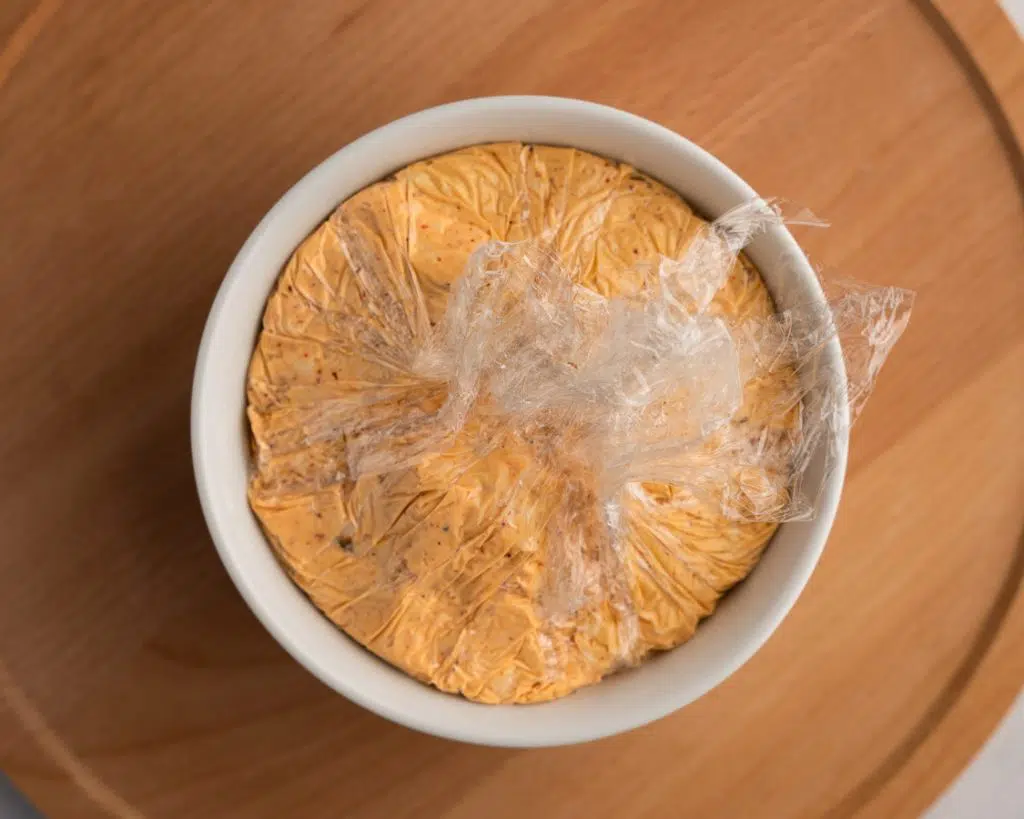 Cheeseball filling molded into a white bowl