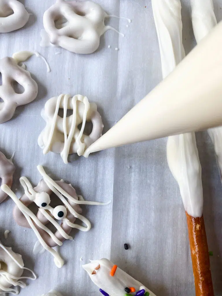 Piping white stripes with melted chocolate.