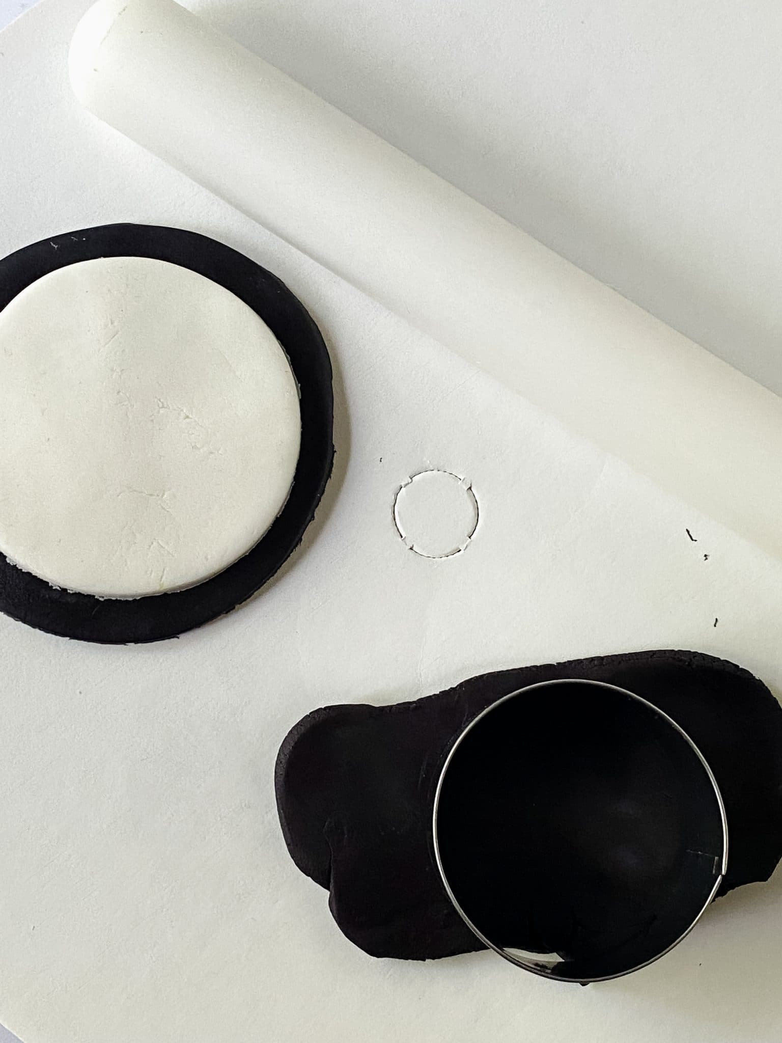 Down view of a circle cutter stamping out fondant to make monster eyes. Hostess At Heart