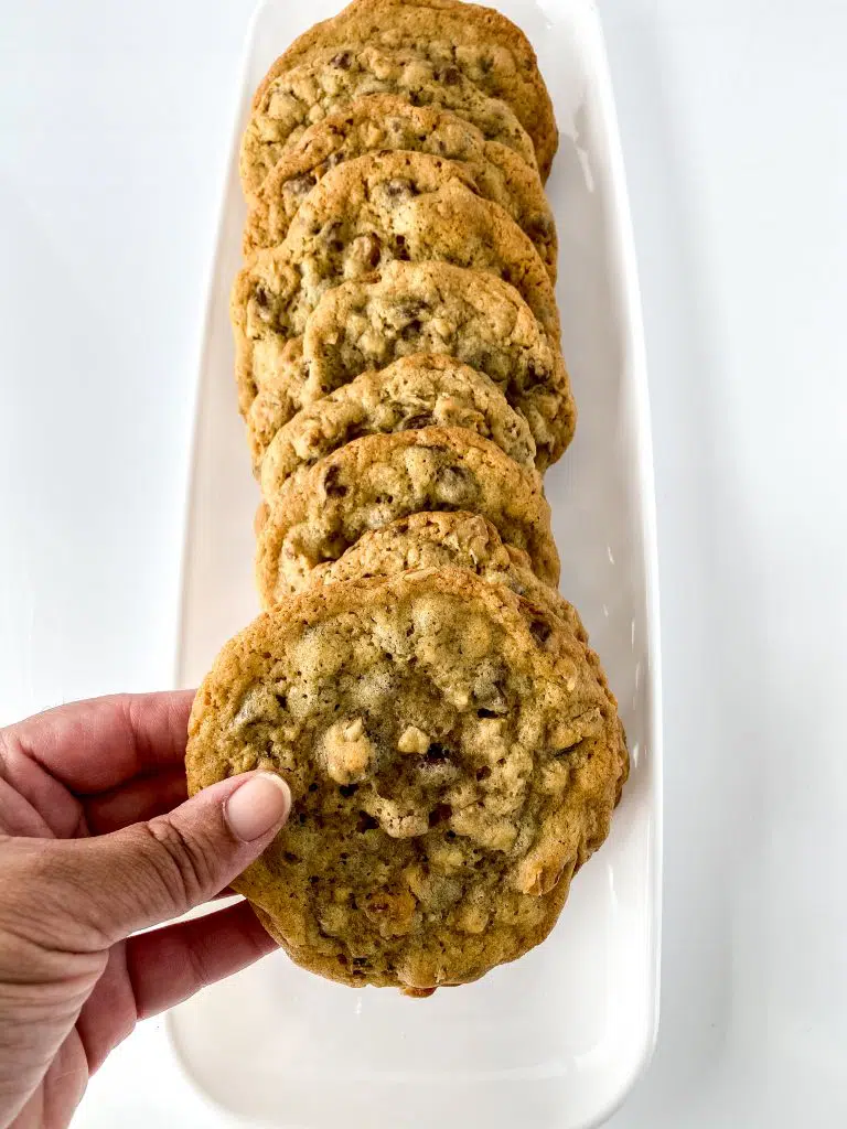 Stacked chocolate chips on a white plate.