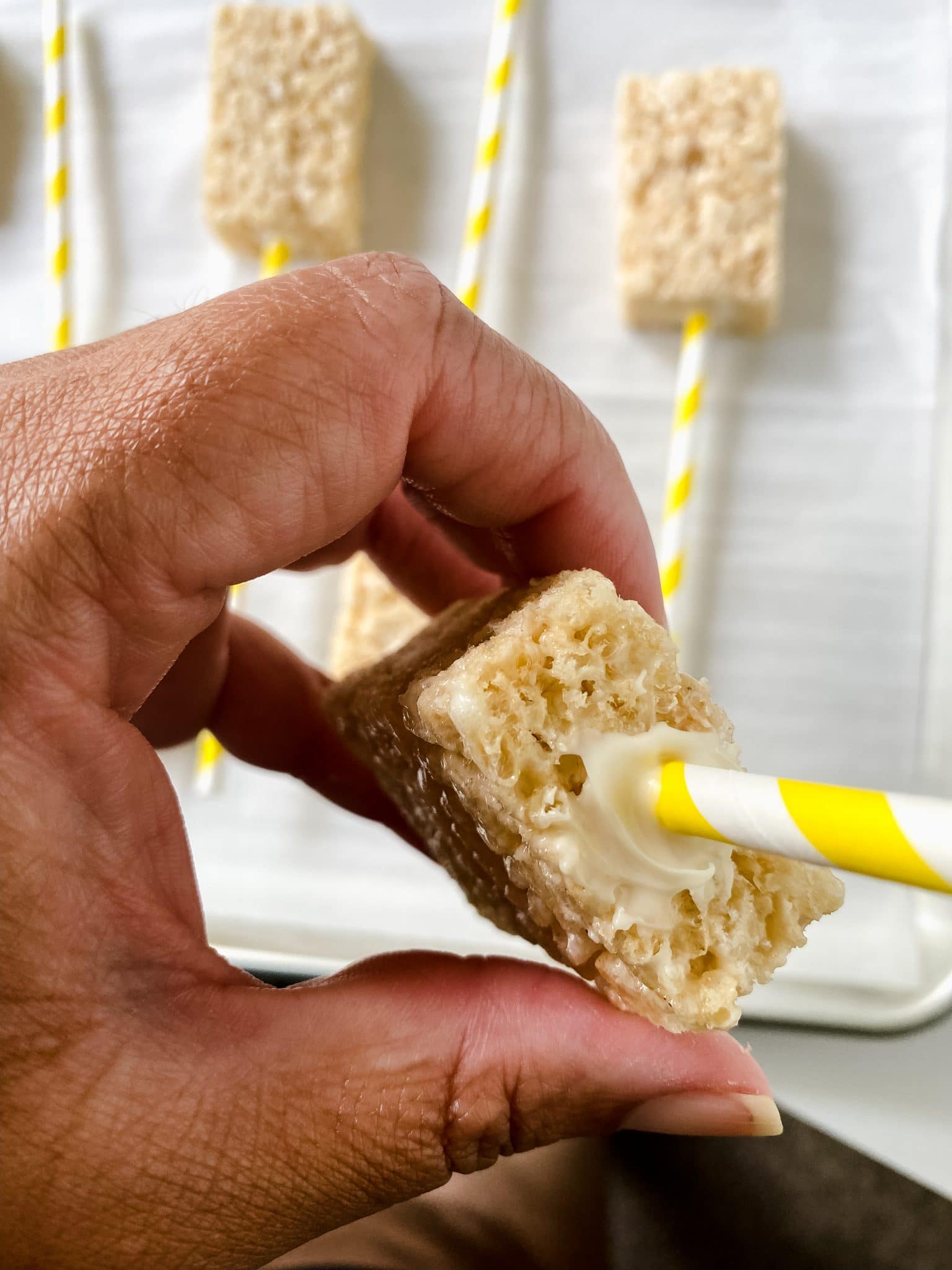 stick going into the end of a Krispie treat.