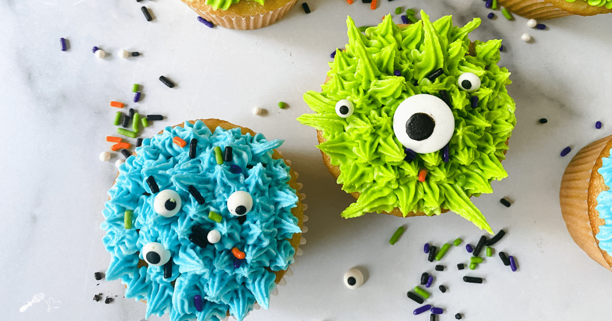 Top down view of two cupcakes decorated to resemble monsters.