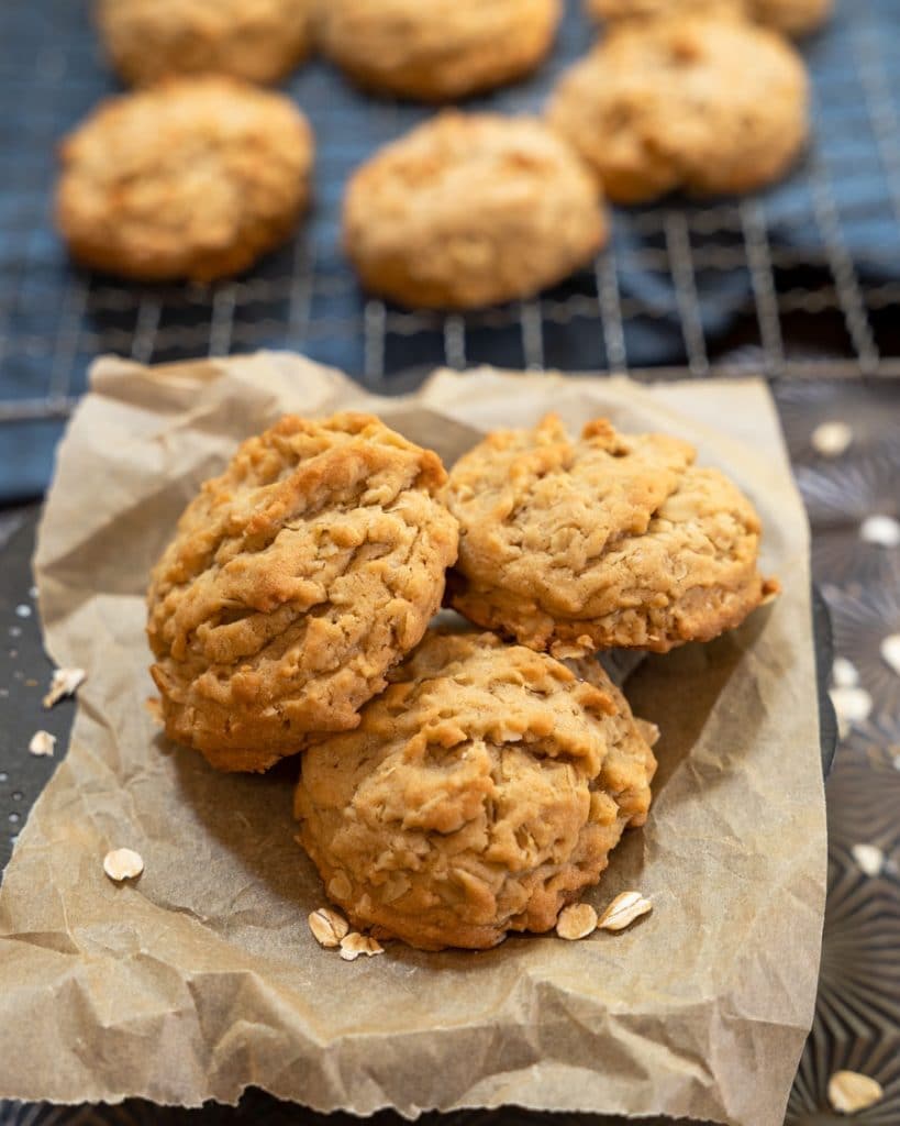 Easy oatmeal cookies on a cooling rack with three in focus.