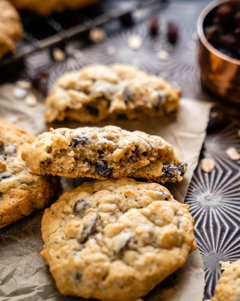 A close-up view of a broken-in-half oatmeal raisin cookie.