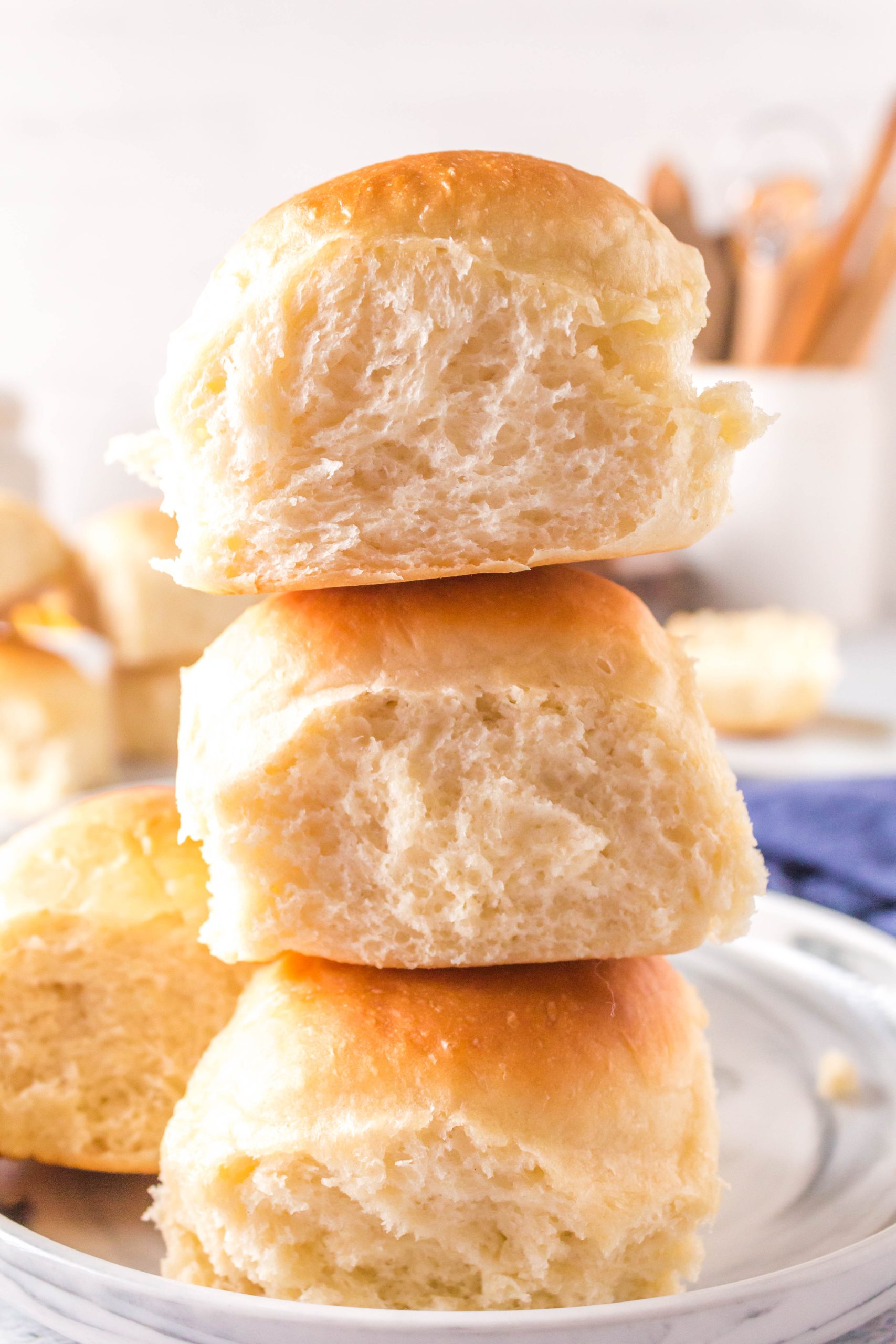 Three soft and fluffy dinner rolls stacked on top of each other - Hostess At Heart