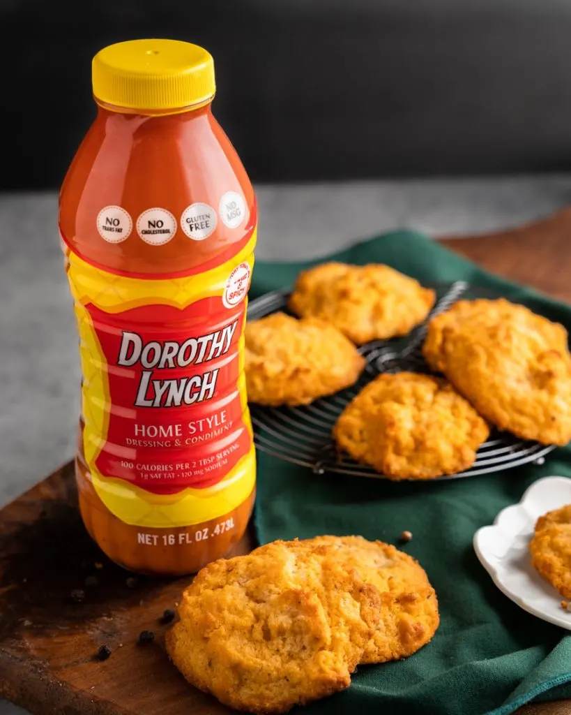 A bottle of Dorothy Lynch Homestyle Dressing & Condiment next to homemade biscuits