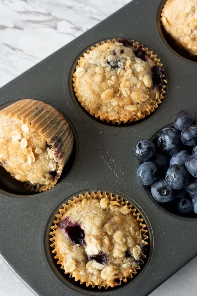 sourdough blueberry muffins in a muffin tin.