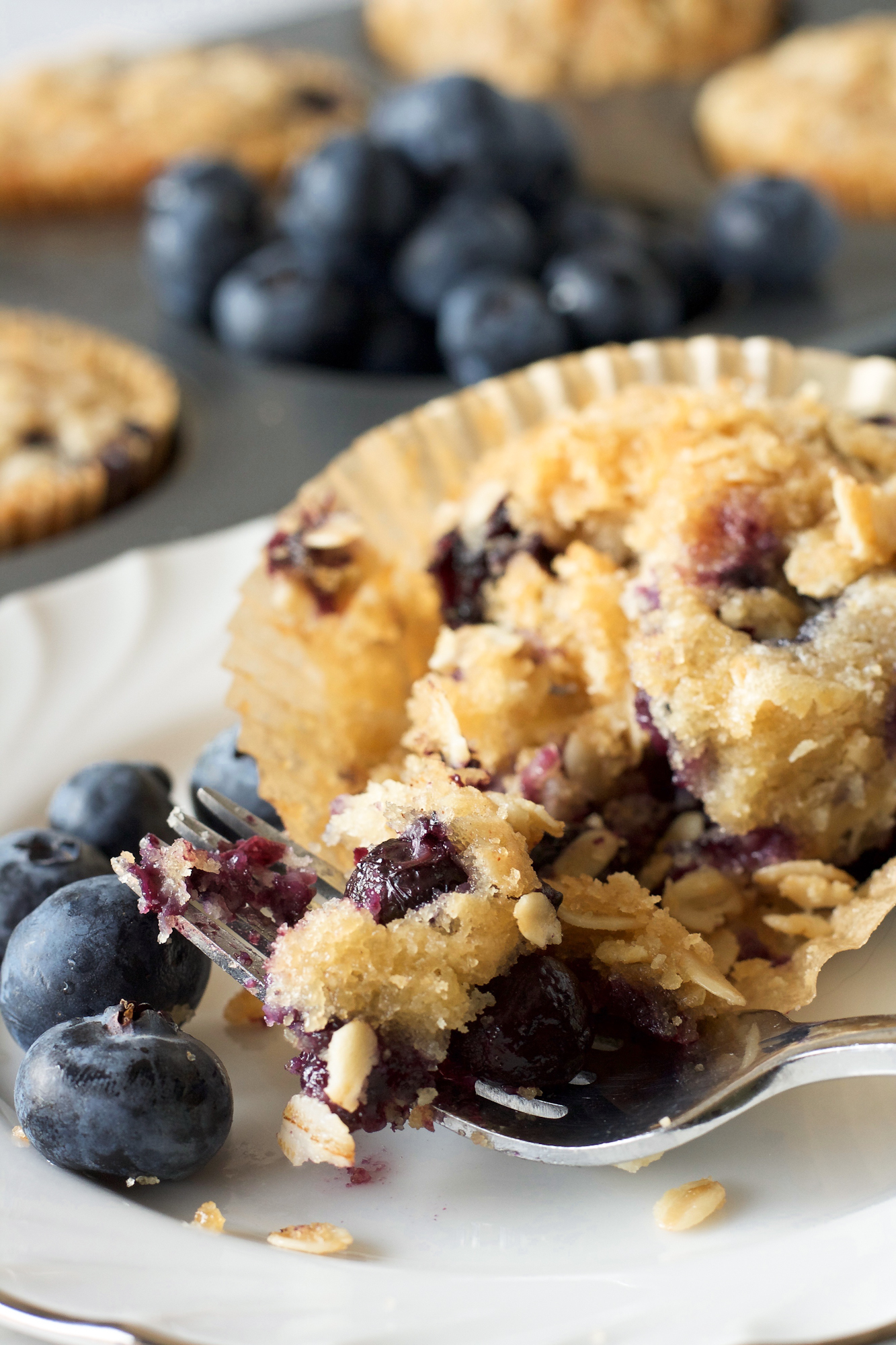 Sourdough blueberry muffin cut in half showing moist crumb and fluffy interior texture. Hostess At Heart