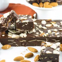 A block of almond fudge topped with cut slices.