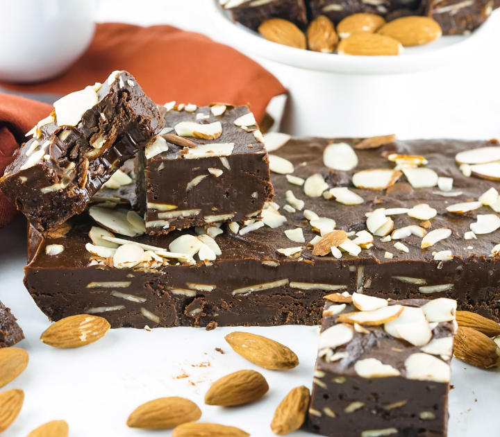 A block of almond fudge topped with cut slices.