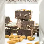 Side view of pieces of chocolate almond fudge stacked on top of each other.