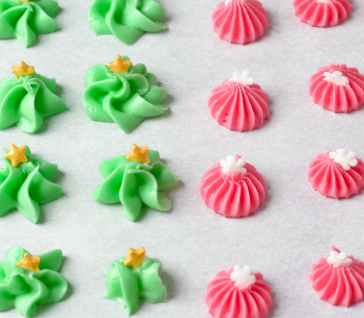 Green and pink cream cheese mints on parchment paper