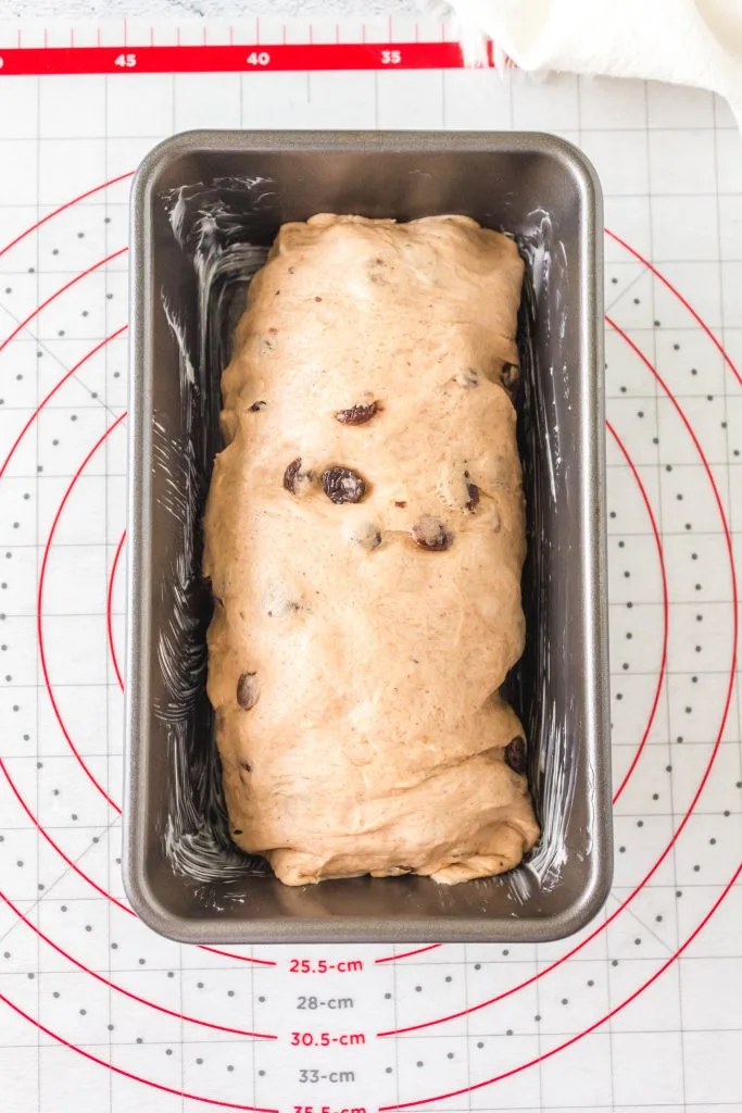 Measuring the dough for the pan using a pastry mat.