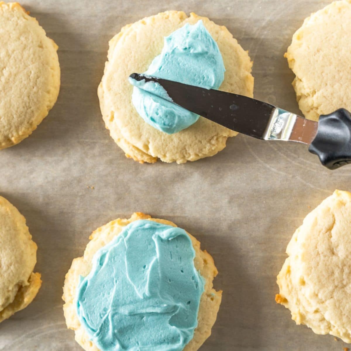 Frosting spread on top of copycat crumbl sugar cookies. Hostess At Heart