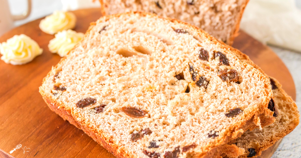 Slices of Raisin Bread laying on a bread board.