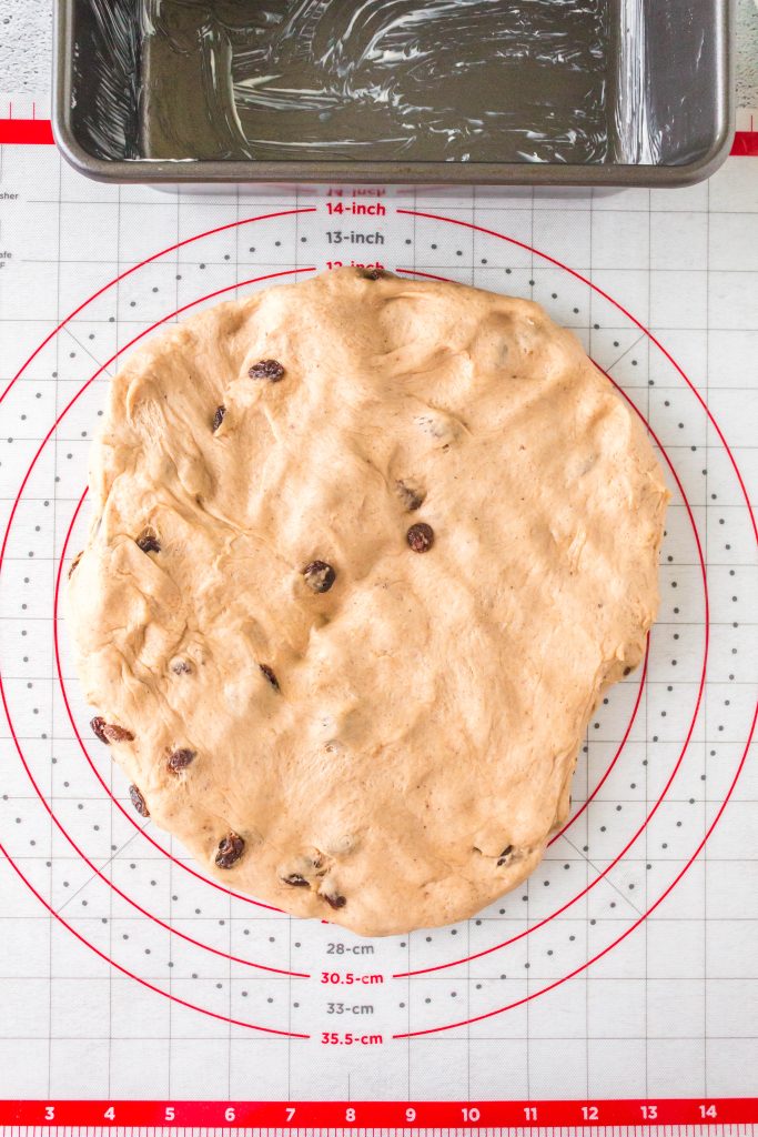 Raisin Bread dough stretched into a rectangle to fold.