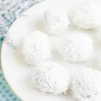 Top down view of White Chocolate Oreo Cookie snowballs on a plate.