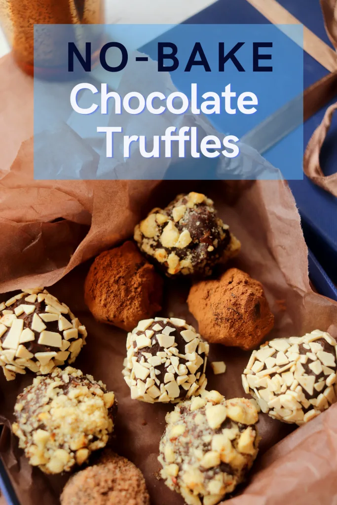 Close-up view of a box of chocolate truffles rolled in nuts or cocoa powder.