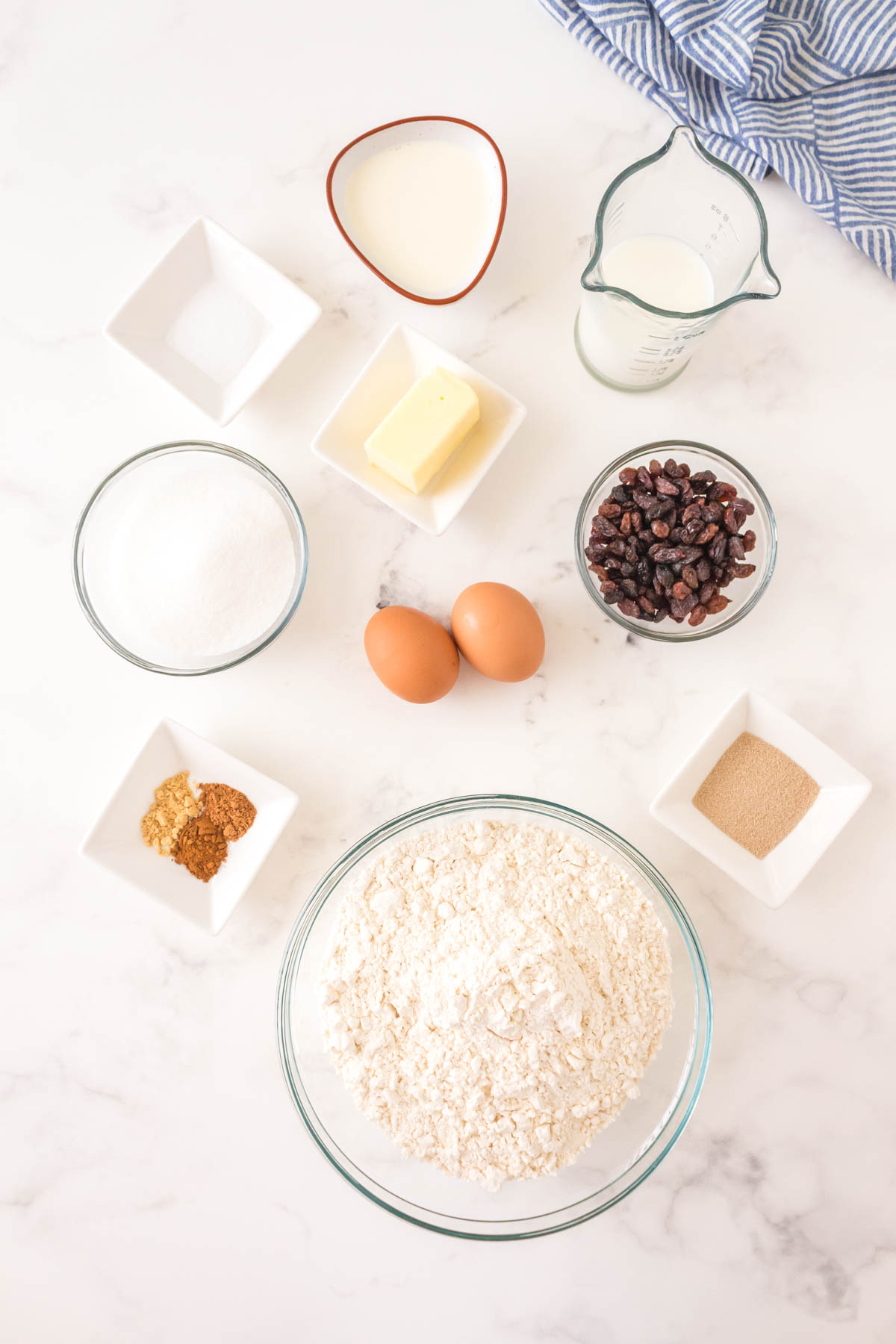 Ingredients for the Hot Cross Bun Recipe: Raisins, Hot Water, Warm Milk
Active Dry Yeast, White Granulated, Sugar, All-Purpose Flour, Cinnamon, Ground Nutmeg, Ginger, Salt, Eggs&nbsp;- grade A large, Heavy Cream, Butter