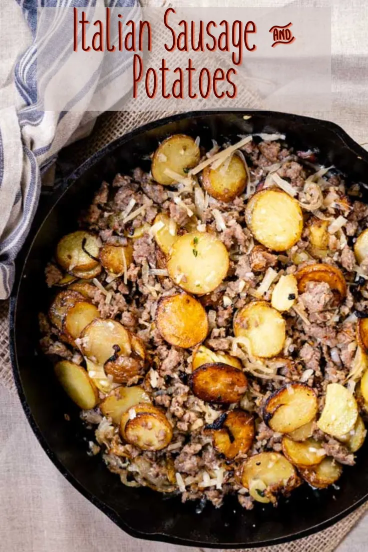 Top down view of a cast iron skillet filled with fried potatoes and ground sausage.