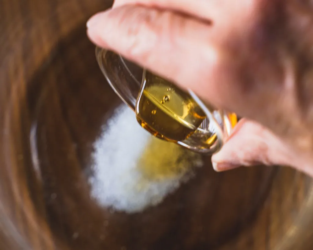 Honey pored over salt and yeast in a bowl