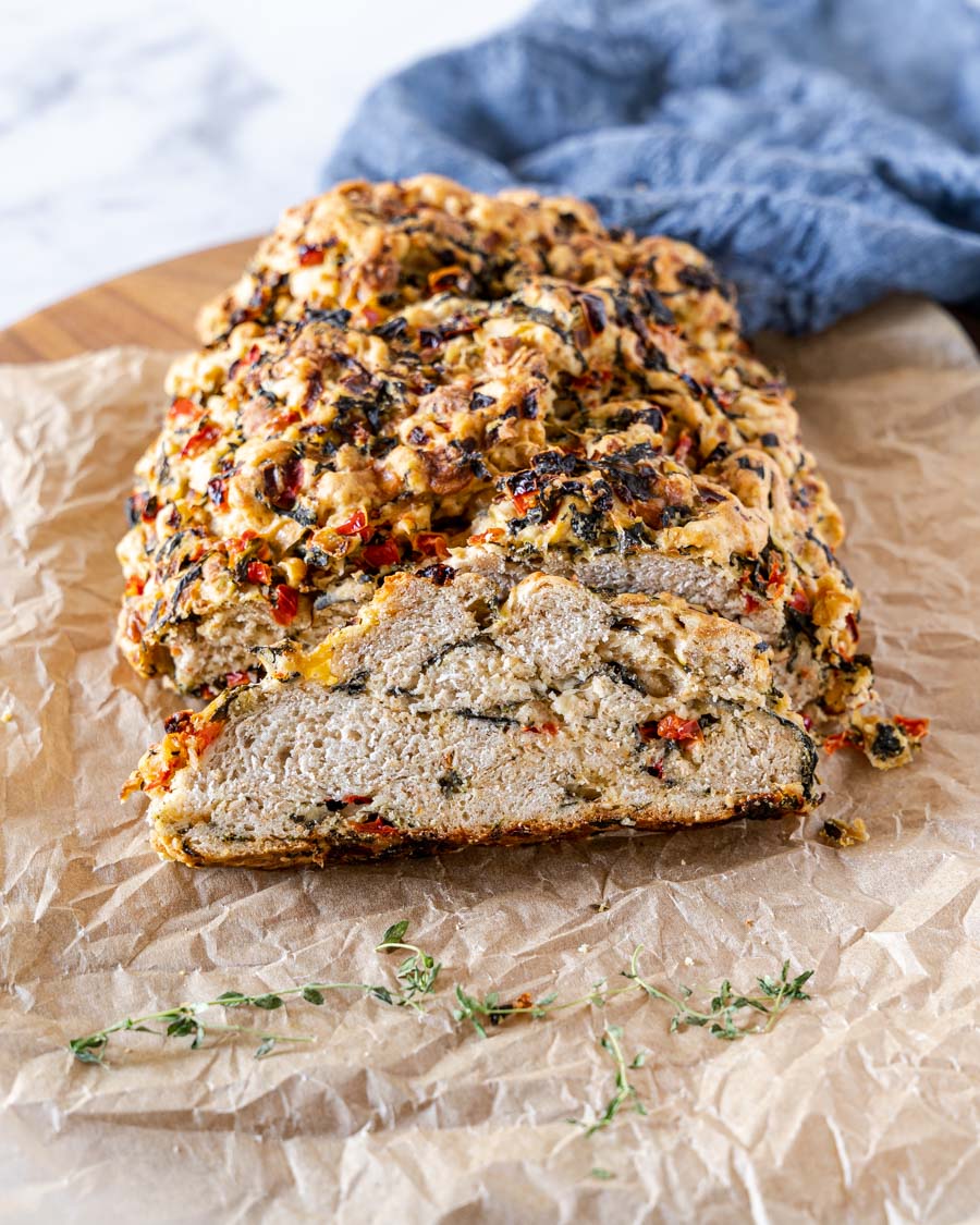 A front view of a sliced loaf of spinach bread.