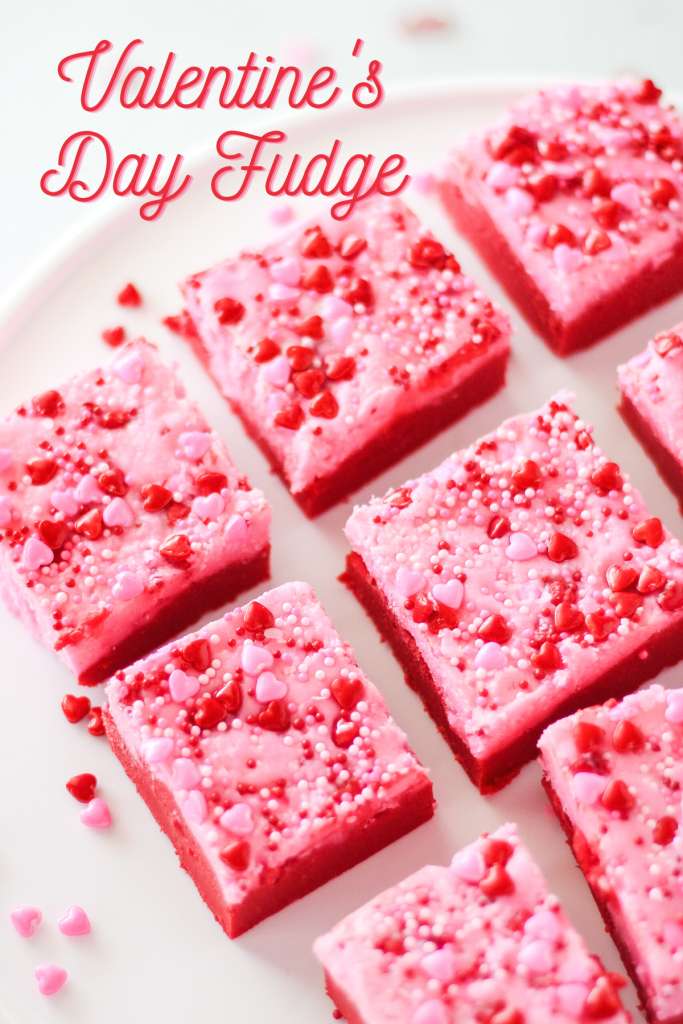Top down view of red fudge frosted pink with heart sprinkles.