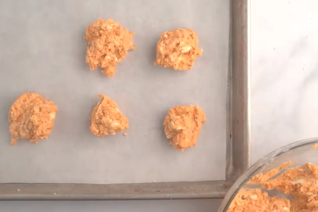 Biscuits dropped by the spoonful onto a cookie sheet.
