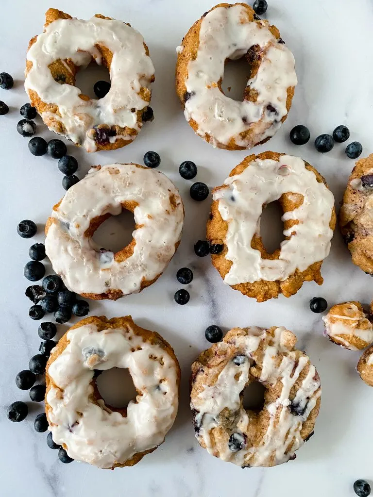 Top down view of blueberry glazed donuts.